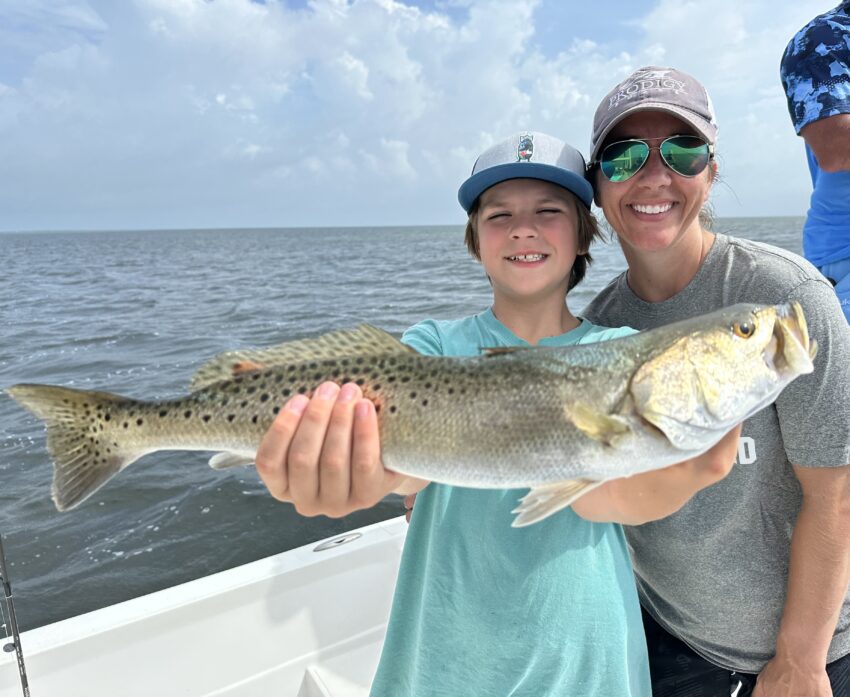 mom and son with big speckled trout